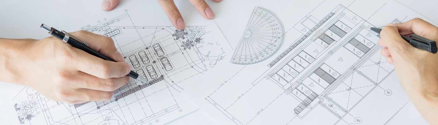 Close view of two architects working on a blueprint