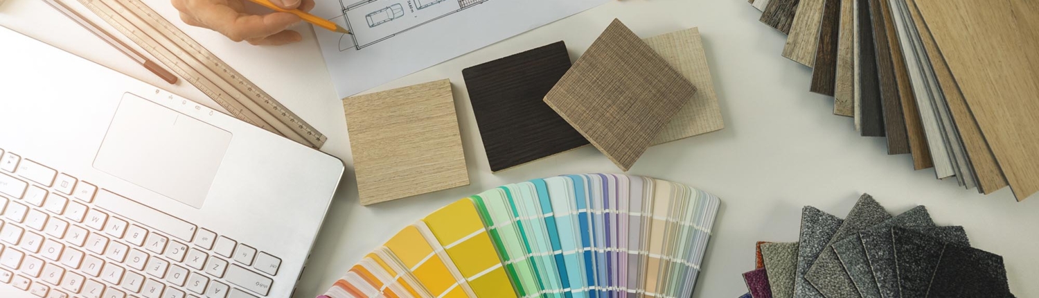 Top view of specialist working in office doing furniture and flooring material selection from samples for home des